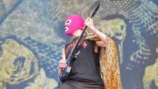 Killswitch Engage guitarist Adam D performing onstage in a wrestling mask at Download 2009