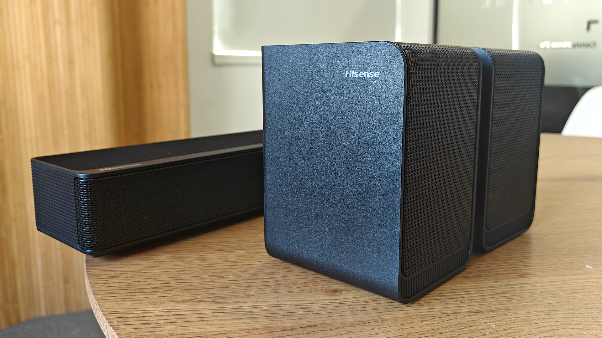 The Hisense AX5125H Dolby Atmos soundbar system, pictured on a round, wooden table