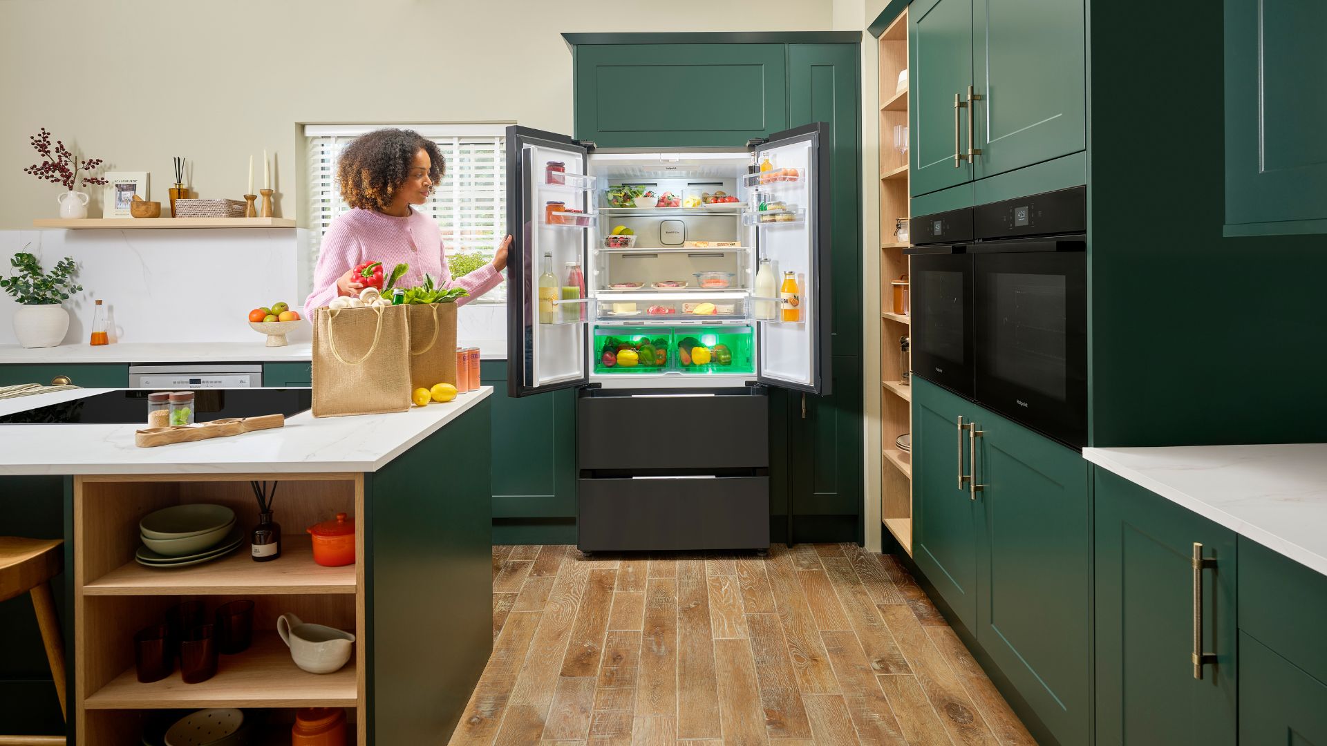 AO Hotpoint American Fridge Freezer in slate in a green kitchen with white walls
