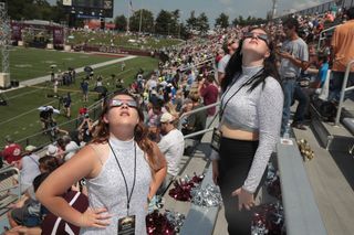 Members of the Southern Illinois University marching band watch the solar eclipse at Saluki Stadium on Aug. 21, 2017.
