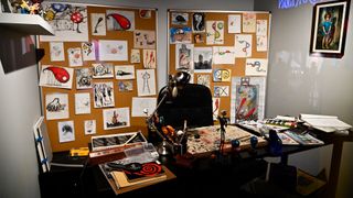 A desk with various Tim Burton illustrations at 'The World of Tim Burton'