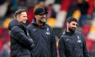 Liverpool manager Jurgen Klopp speaks to his staff Pepijn Lijnders, Assistant Manager, (L) and Vitor Matos, Elite Development Coach, prior to the Premier League match between Brentford FC and Liverpool FC at Gtech Community Stadium on February 17, 2024 in Brentford, England.