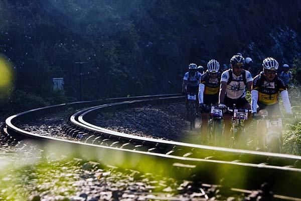 Racers beside the railroad tracks.