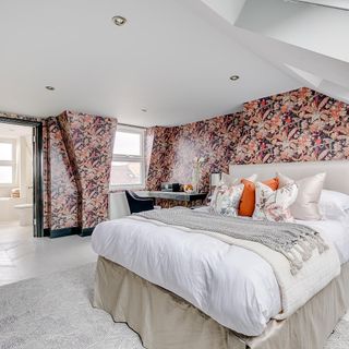 bedroom with printed walls and bed with pillows