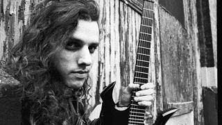 Death’s Chuck Schuldiner holding a guitar