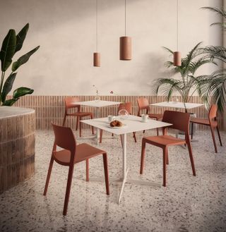 orange dining chairs on a terazzo floor