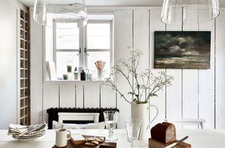 cottage kitchen with white walls and white table and chairs