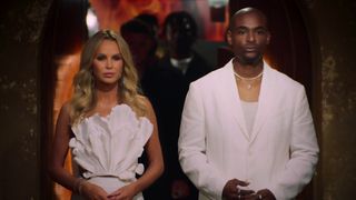 Amanda Holden and Paul Carrick Brunson both wearing white and looking serious in Cheat: Unfinished Business.