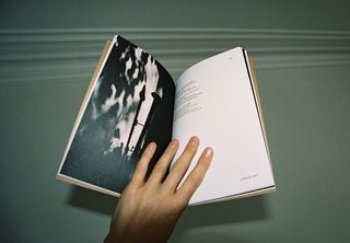 hand on open book