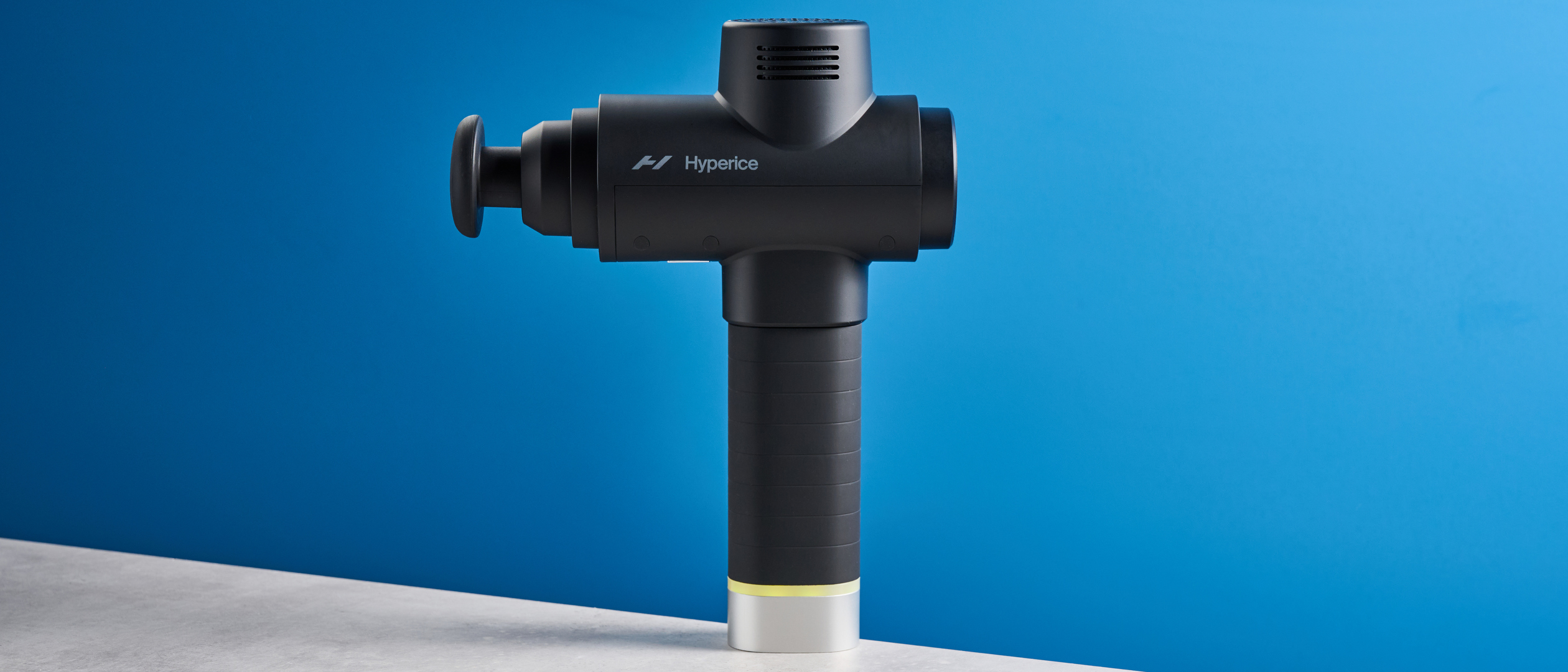 the hyperice hypervolt 2 pro massage gun with a long ergonomic handle and interchangeable massage head attachments