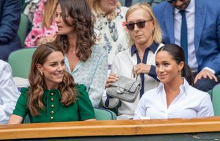 Catherine, Duchess of Cambridge and Meghan, Duchess of Sussex in the Royal Box on Centre Court at Wimbledon