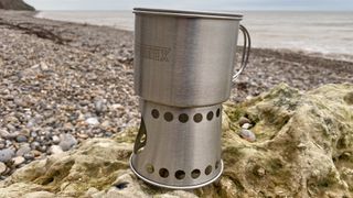 Petromax Stove Cup / Cooking Mug on rock at the beach