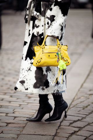 a woman at Copenhagen Fashion Week carrying a Balenciaga city bag