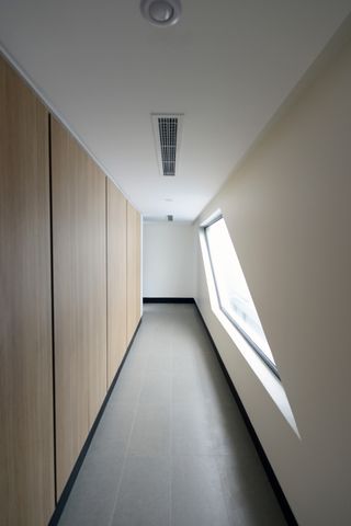 corridor with angled window in micro house in Kuwait
