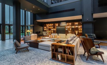 Large gray sofa and wooden interior in Hall.