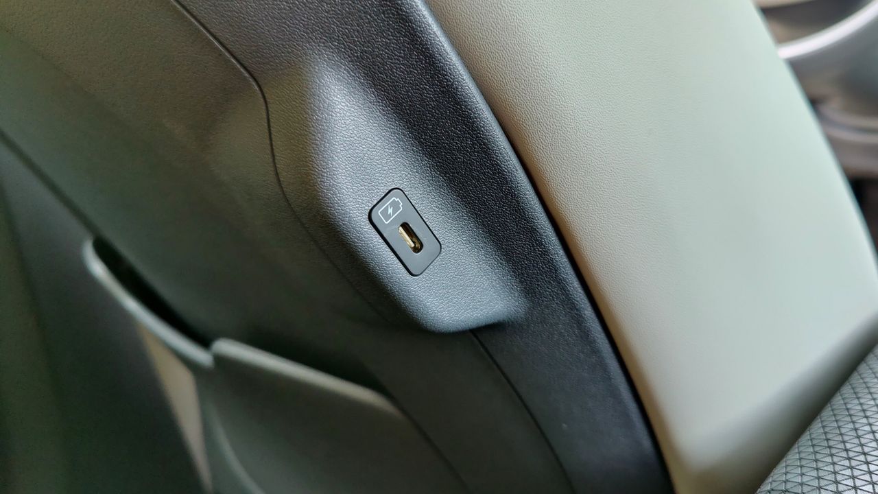 Close-up of a USB-C port embedded on the side of a car seat