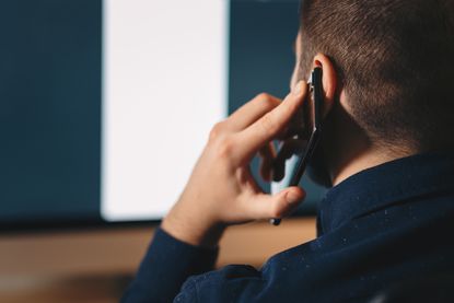 A man using a telephone.