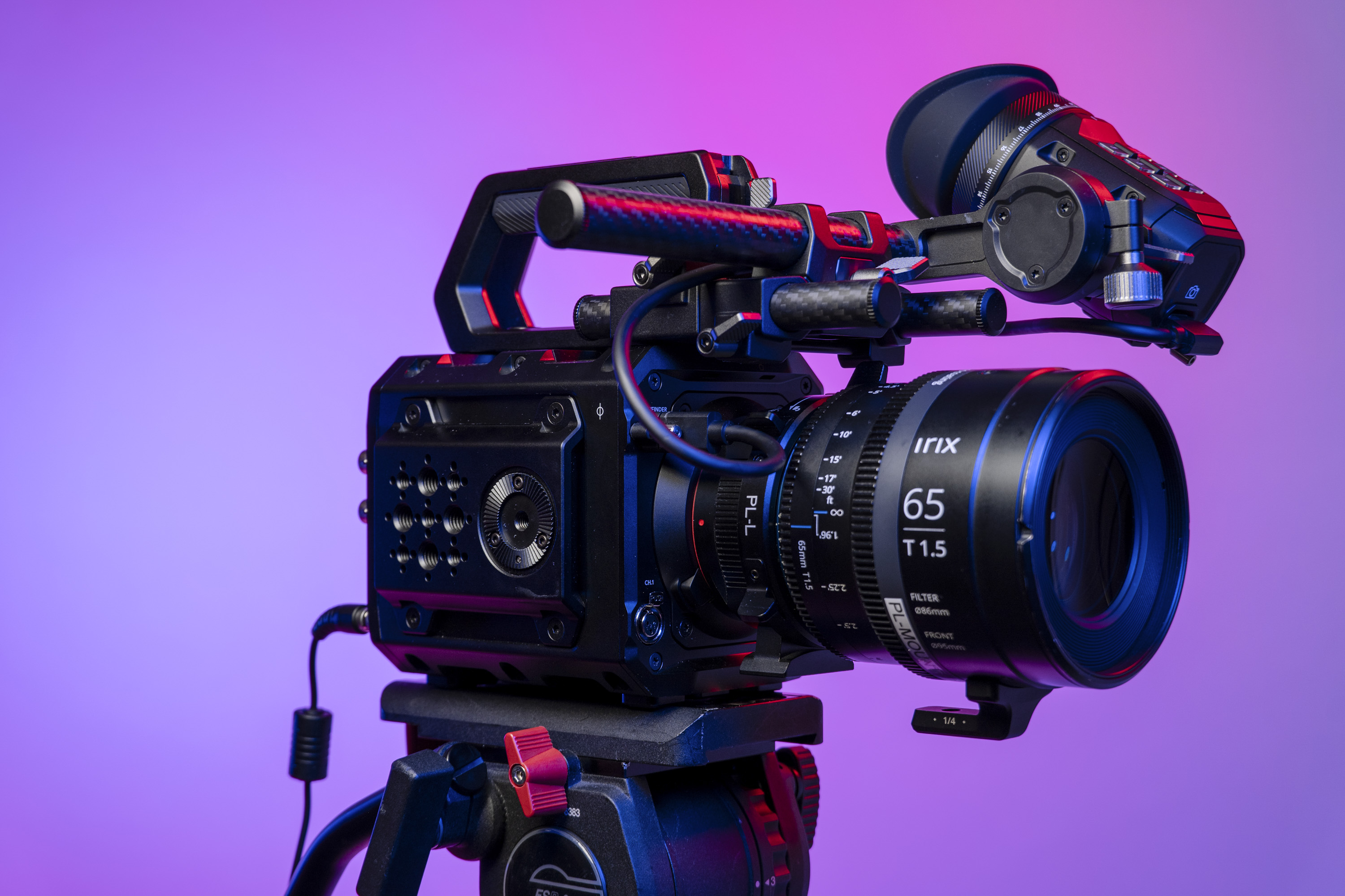 Blackmagic Pyxis 6K camera in the studio, mounted to video tripod, with a vibrant magenta background