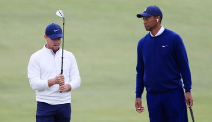 Rory and Tiger chat whilst Rory holds a wedge
