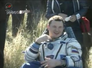 Soyuz commander Roman Romanenko, a Russian cosmonaut, smiles after being pulled from his Soyuz spacecraft following a smooth landing on May 14, 2013 (May 13 EDT) to end a five-month mission to the International Space Station.