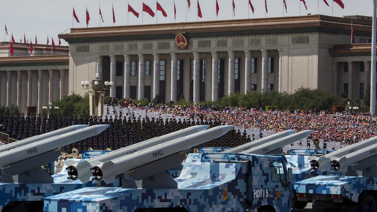 Chinese missiles seen on trucks as they drive next to Tiananmen Square