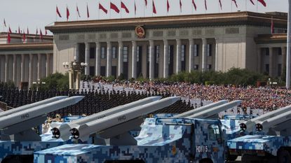 Chinese missiles seen on trucks as they drive next to Tiananmen Square