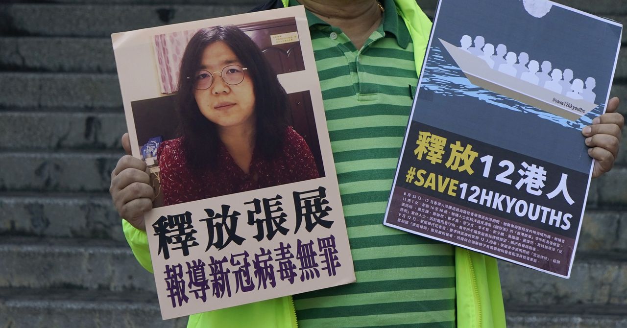 A supporter holds a picture of Zhang Zhan.