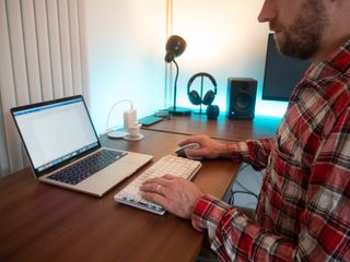 A white Logitech MX Keys Mini for Mac keyboard sitting on a desk