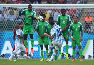 Lionel Messi scores a free-kick for Argentina against Nigeria at the 2014 World Cup.