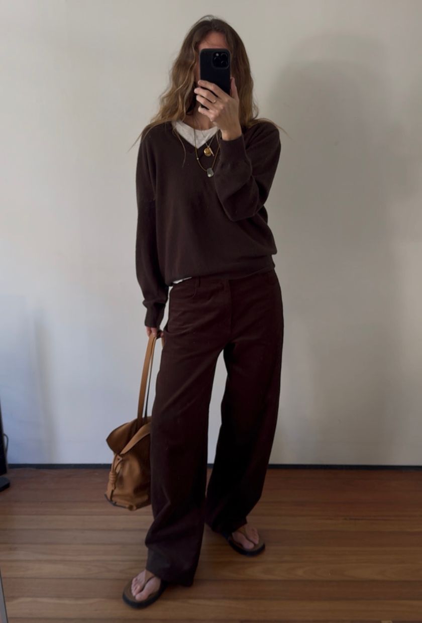 Angie wears a John Lewis jumper, bear park cords, loewe bag and the row sandals