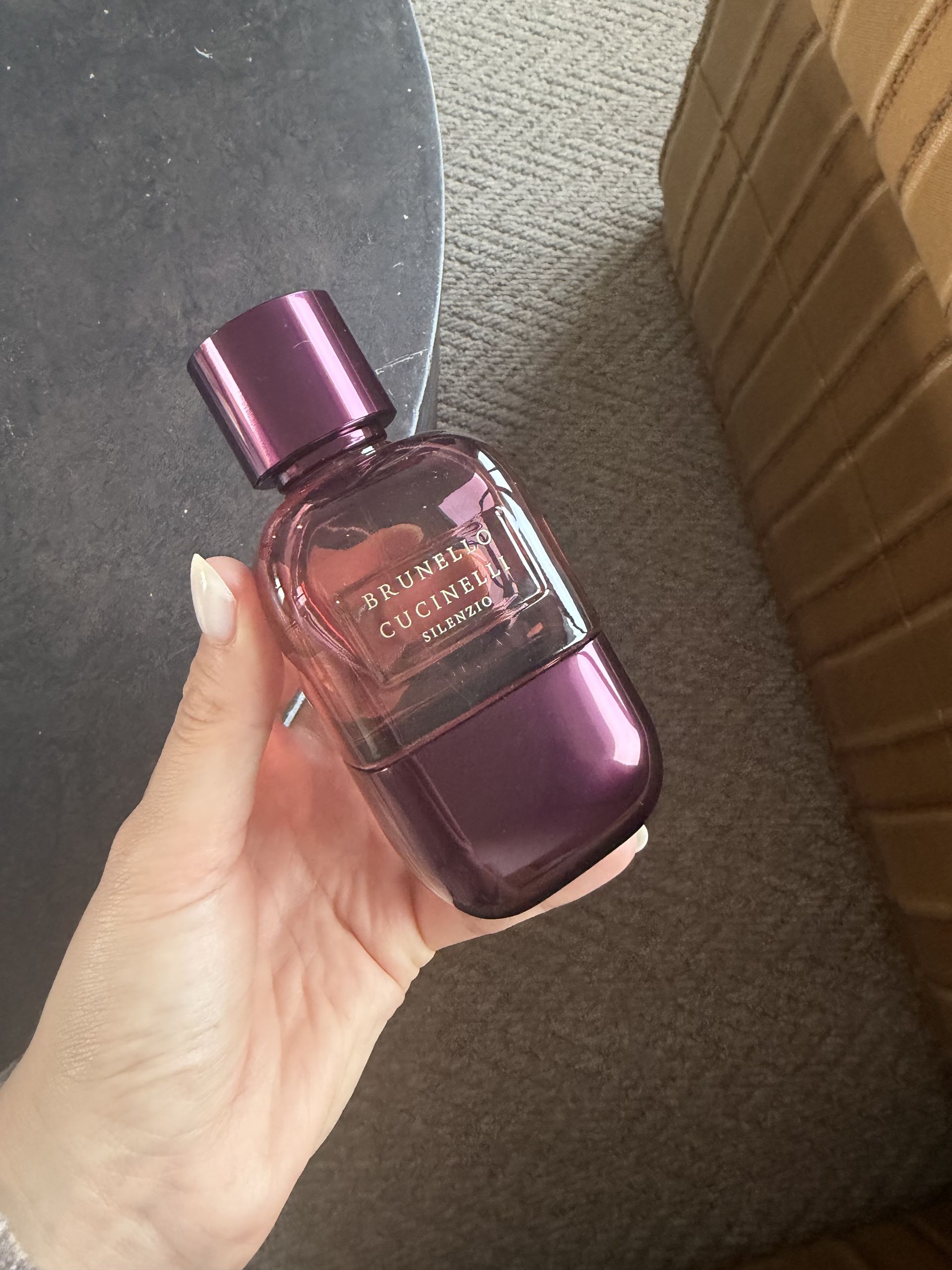 Shannon Lawlor holding a bottle of Brunelle Cucinelli Silenzio