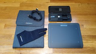 Xencelabs Pen Tablet Small review; a drawing tablet, case, pen case and leads on a wooden table