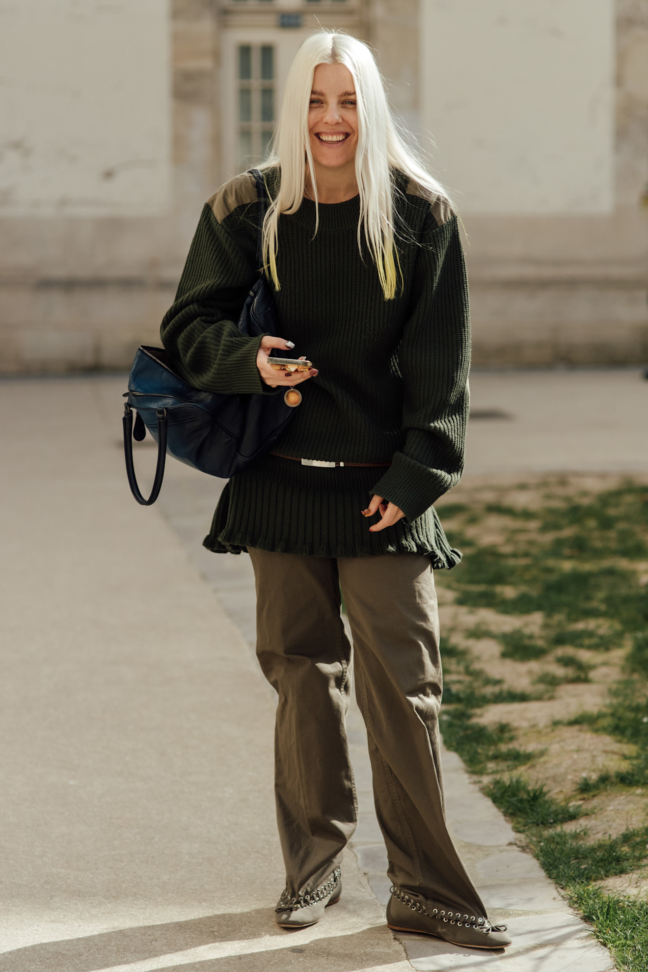 woman wearing a green pair of pants and a black top