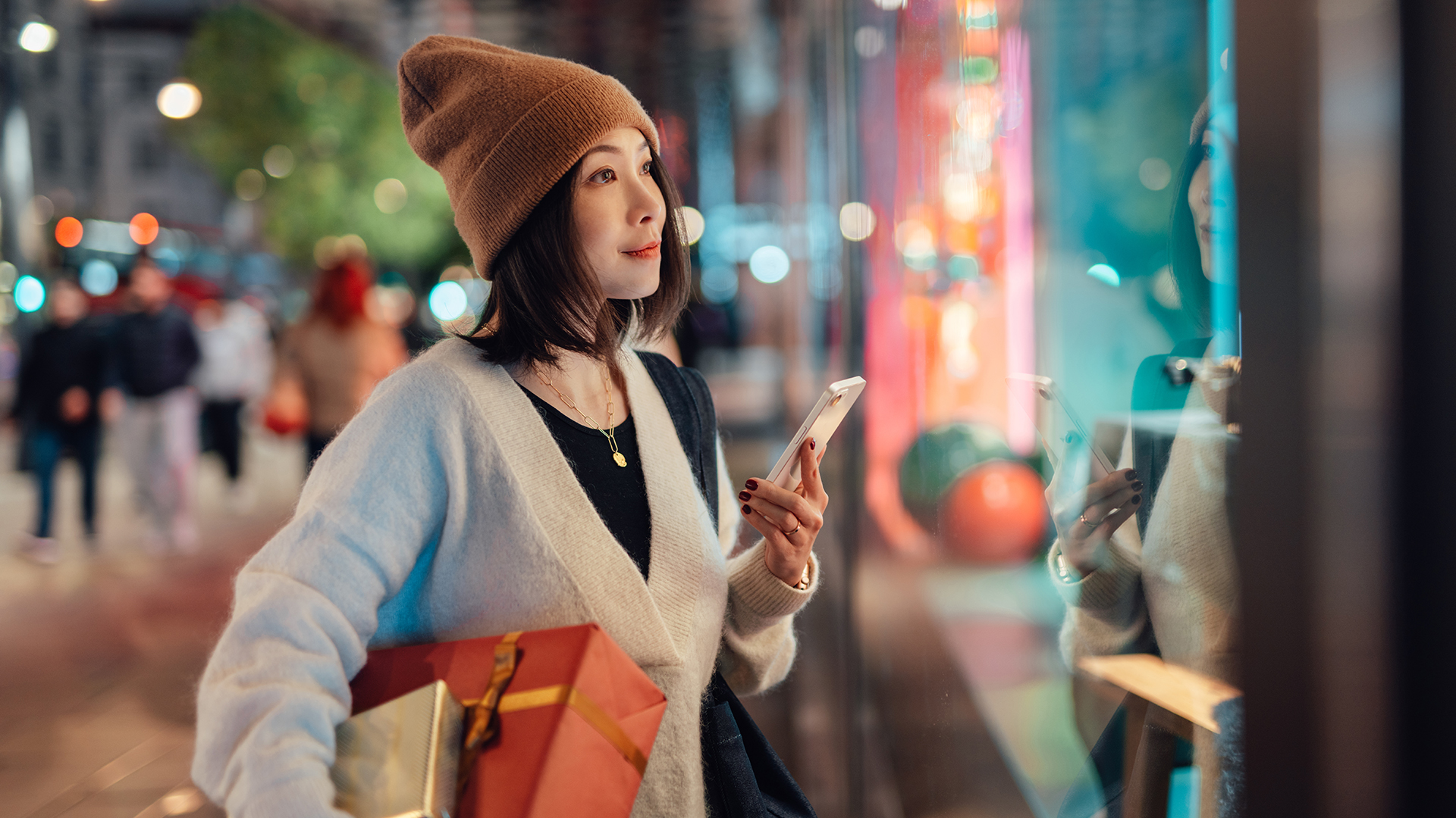 Woman shopping at Christmas – holding a phone