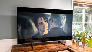 Hisense U8H Mini-LED TV on living room tv stand