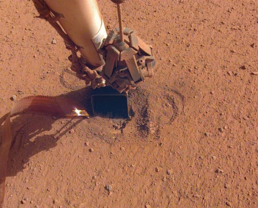 NASA&#039;s InSight Mars lander has used the scoop on the end of its robotic arm to help the mission’s burrowing heat probe, known as the &quot;mole,&quot; get and stay underground. 