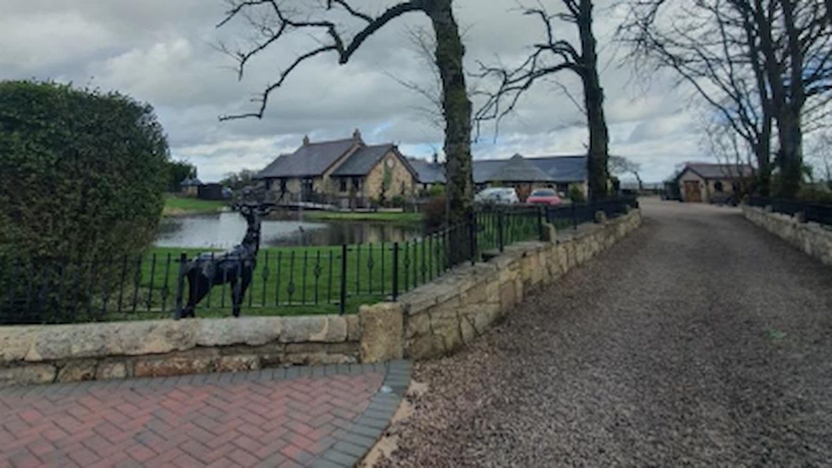 A sandstone self build at the end of a long gravelled driveway