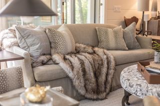 neutral living room textured cushions, sheepskin throw, textured rug