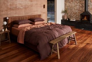 A bedroom with brown and orange bedding