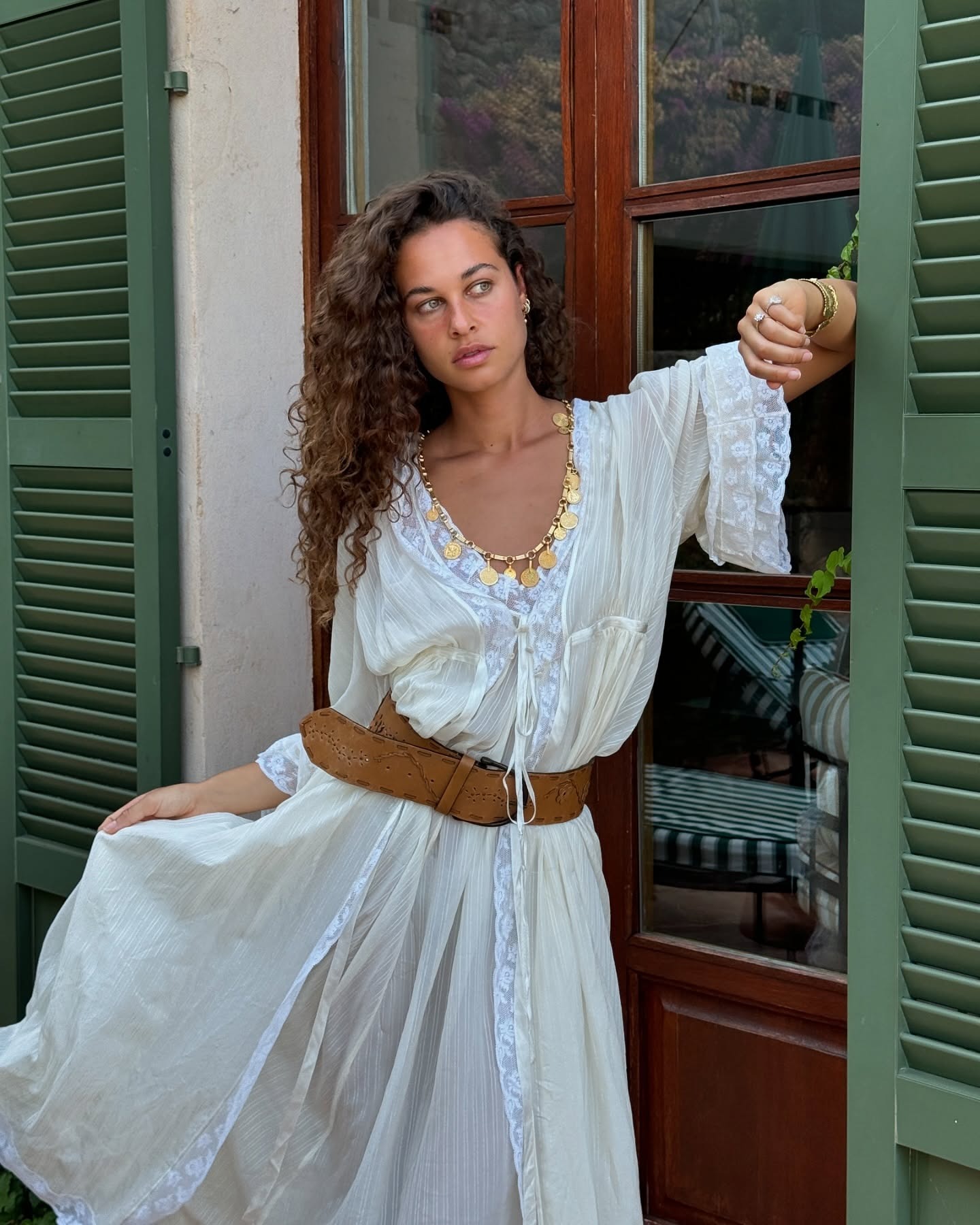 Fashion person Sarah Lysander wears boho outfit ideas. She wears a Maxi dress with lace detailing, brown suede belt and chunky necklace in a recent image from her Instagram