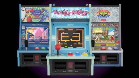 Evercade Alpha Taito Edition with Mega Man version behind on left and Street Fighter 2 version on right with black backdrop.