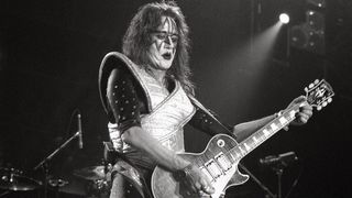 Ace Frehley performing live on stage, playing Gibson Les Paul Custom guitar
