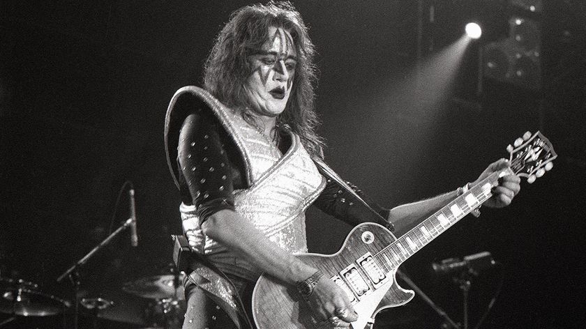 Ace Frehley performing live on stage, playing Gibson Les Paul Custom guitar 