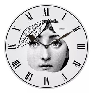 A black and white clock with a sketched face in the middle