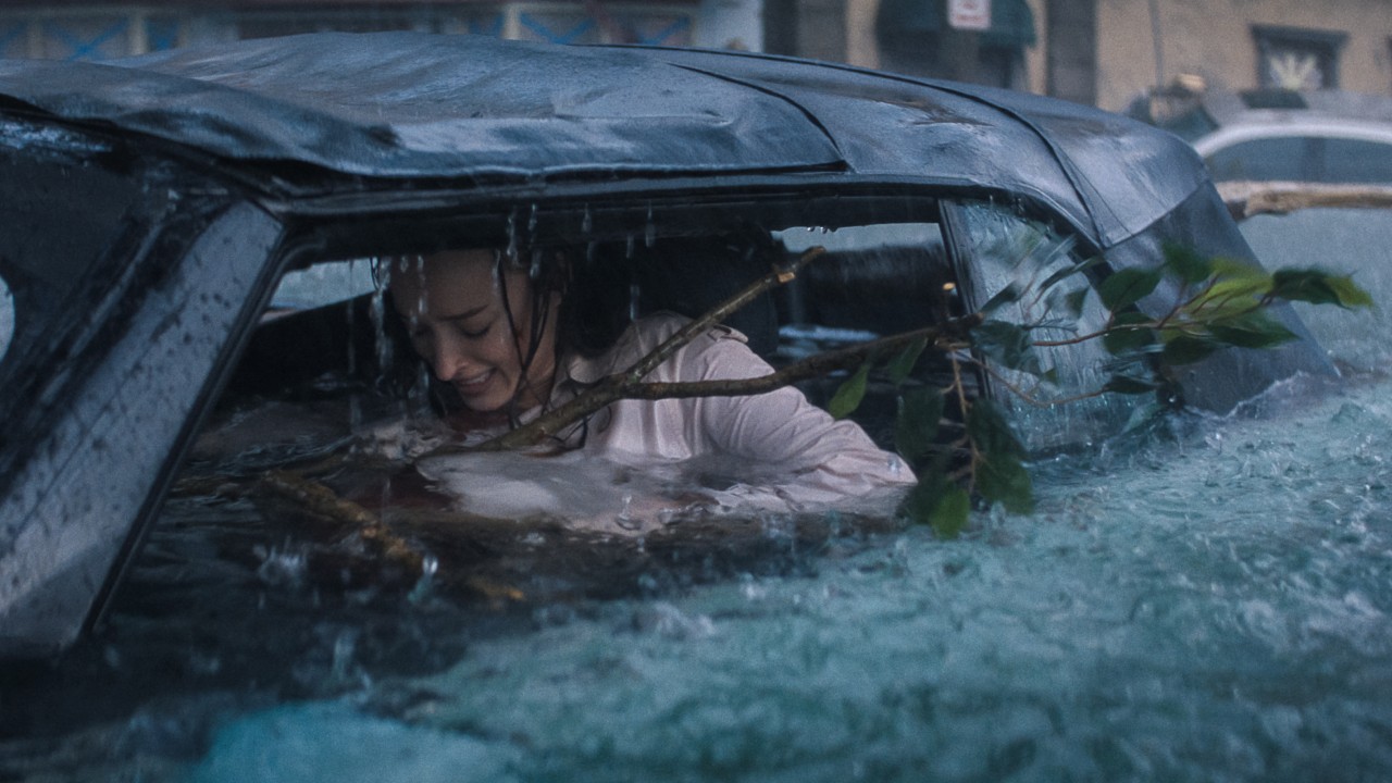 A woman struggles to get out of her car