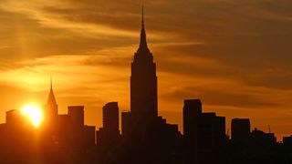 The sun rises behind midtown Manhattan and the Empire State Building in New York City. On the morning of Nov. 11, 2019, Mercury will transit the rising sun.