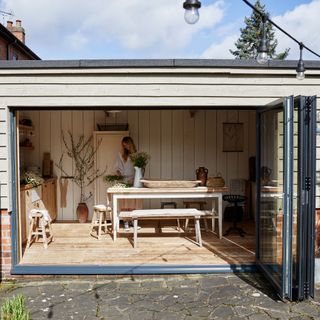 Garden workshop/office with large farmhouse table and bench
