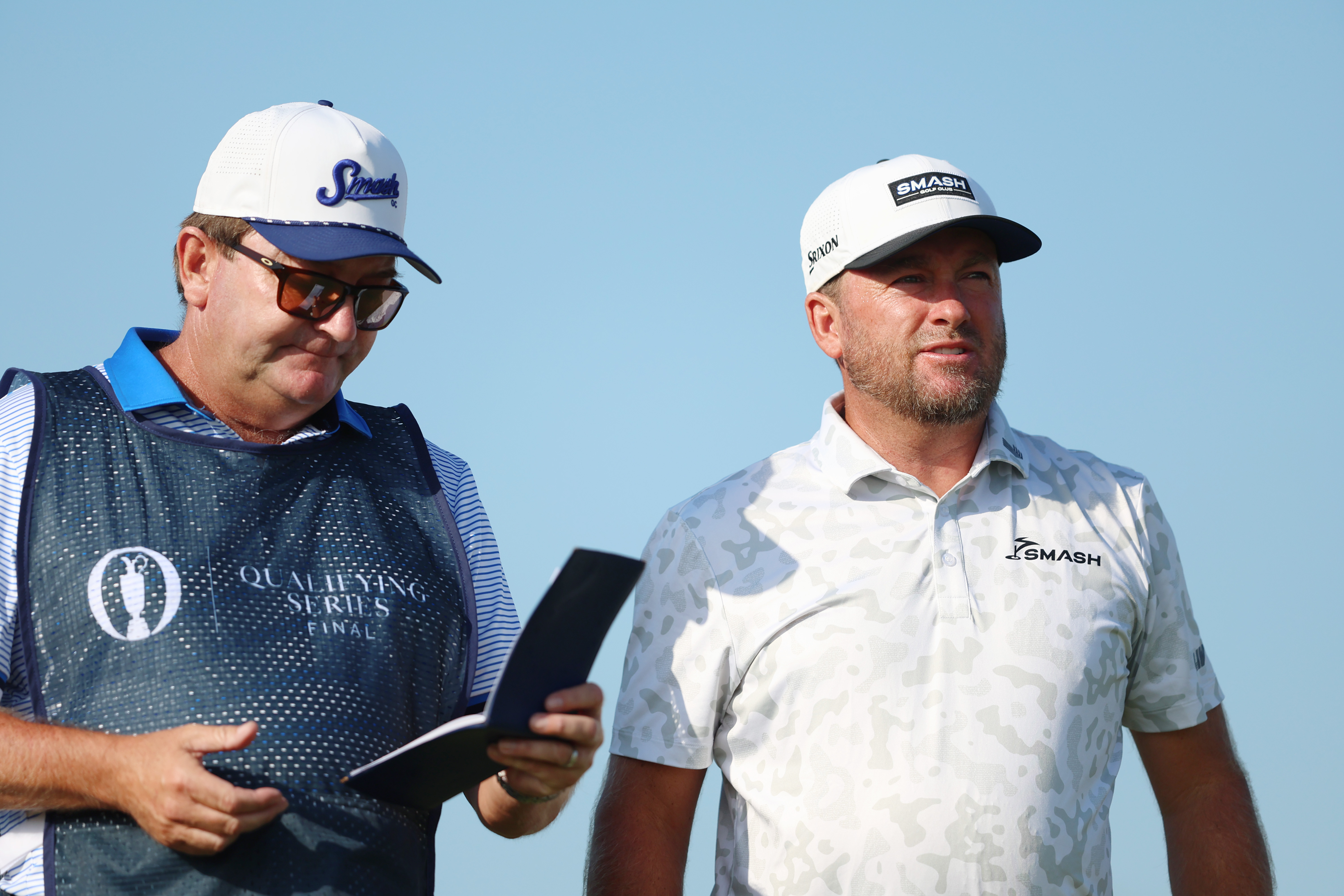 Graeme McDowell speaks to his caddie