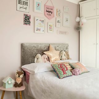 kids bedroom with bed with toys and cushions