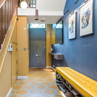 hallway with blue walls and printed flooring